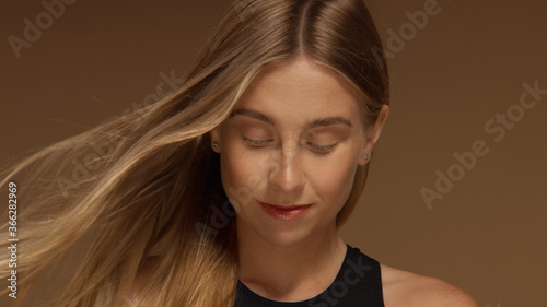 Canvas Print surf style looking blonde girl with hair bloowing looking down