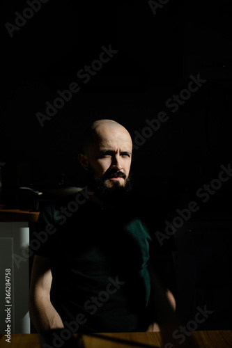 Abstract portrait of a man with a beard in the sun. Minimalism of the forms of light and shadow.