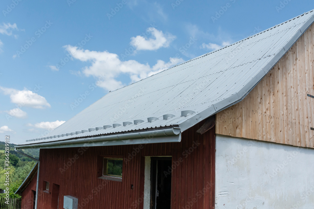 red barn with sheet metal roof