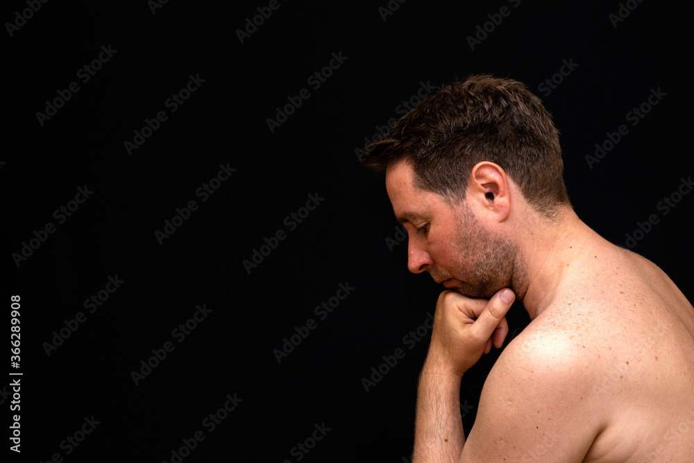 Side view sad thoughtful undressed handsome male demonstrating reverie. Side view sad thoughtful undressed handsome male demonstrating reverie.