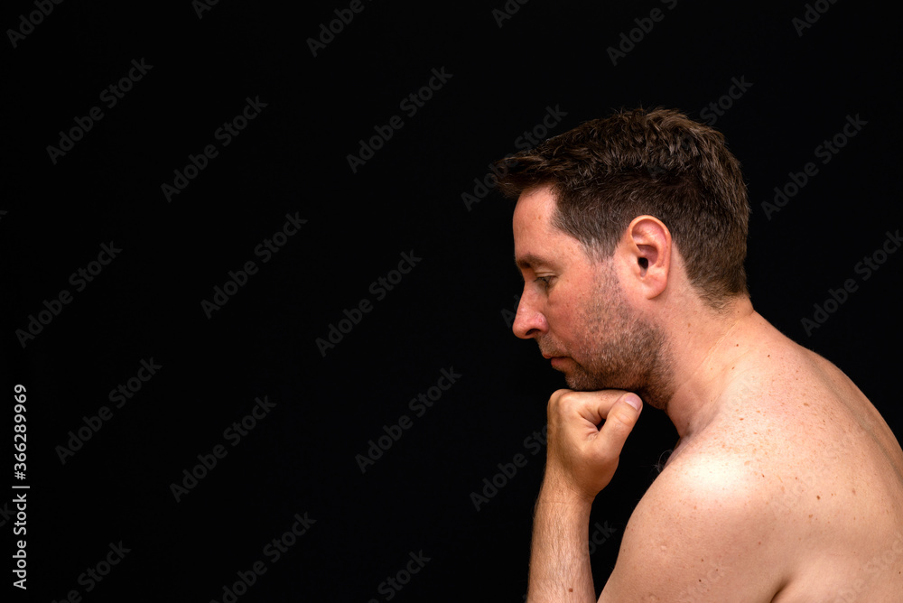 Side view sad thoughtful undressed handsome male demonstrating reverie. Side view sad thoughtful undressed handsome male demonstrating reverie.