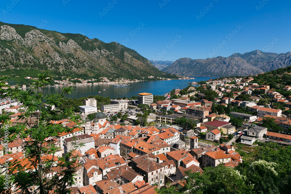 Kotor bay view in Montenegro, summer time. Kotor town. Mountains, water, red roofs of the old city below. Tourist route to the height. Observation decks on the way.