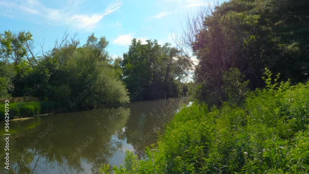 Bright River Landscape with Trees Water and Blue Skies - Guelph Ontario Canada Bright River Landscape with Trees Water and Blue Skies - Guelph Ontario Canada