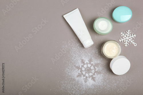 Winter care cosmetics on a colored background top view, place to insert text, minimalism. Skin care, skin hydration
