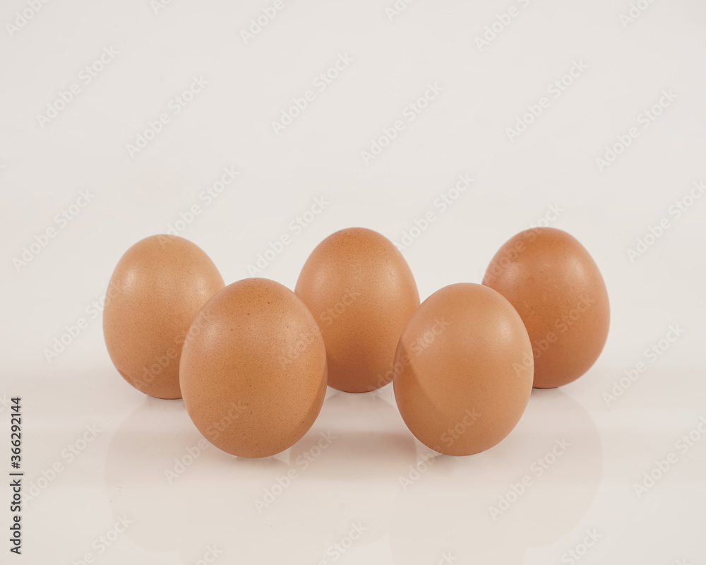 some chicken eggs laid out stand isolated on white background. These health premium eggs are commonly used for advertising or promo materials. some chicken eggs laid out stand isolated on white background. These health premium eggs are commonly used for advertising or promo materials.