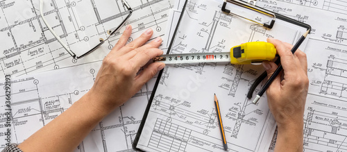 architect design working drawing sketch plans blueprints and making architectural construction model in architect studio,flat lay