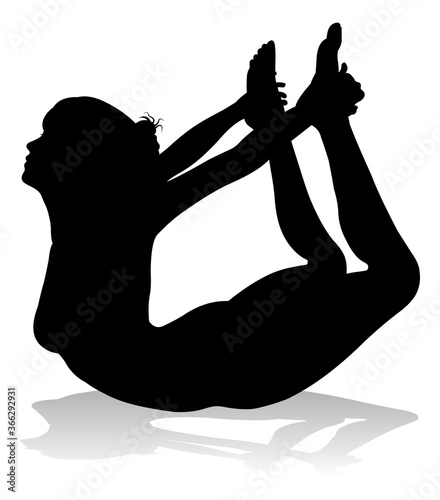 A silhouette of a woman in a yoga or pilates pose