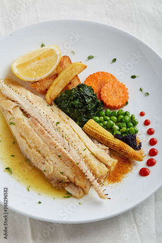 Fish dish, fried fish fillet and vegetables