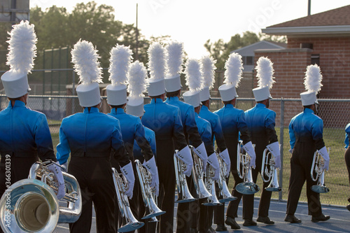 Young People marching in a band with trumpets and other instruments. 