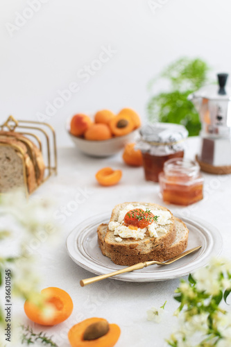 Beautifully served summer breakfast with toasted bread and homemade apricot jam
