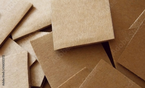 Scattered square pieces of cardboard close up