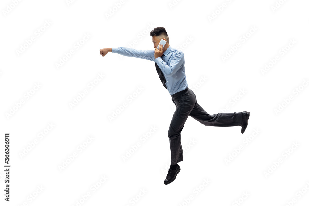 Strong. Man in office clothes practicing taekwondo on white background like professional player, sportsman. Unusual look for businessman in motion, action with ball. Sport, healthy lifestyle Strong. Man in office clothes practicing taekwondo on white background like professional player, sportsman. Unusual look for businessman in motion, action with ball. Sport, healthy lifestyle
