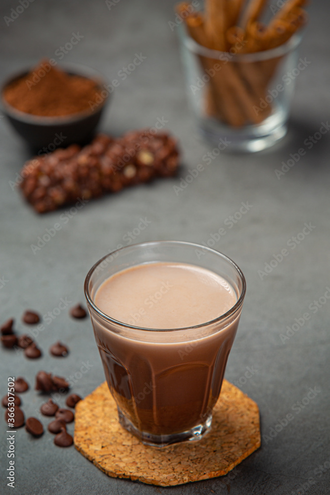 Cocoa served with a delicious chocolate dessert on a black background.. Cocoa served with a delicious chocolate dessert on a black background..