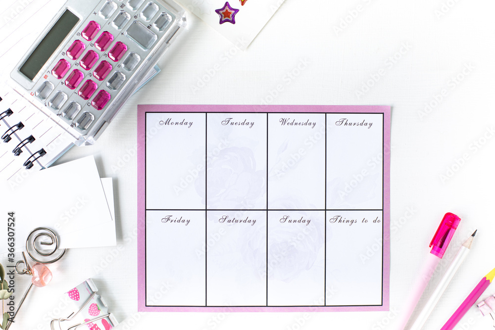 Fototapeta premium Glider with notes and to-do list on a white background with pink stationery. Business concept