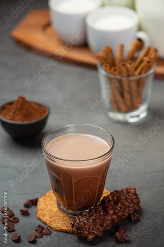 Cocoa served with a delicious chocolate dessert on a black background..