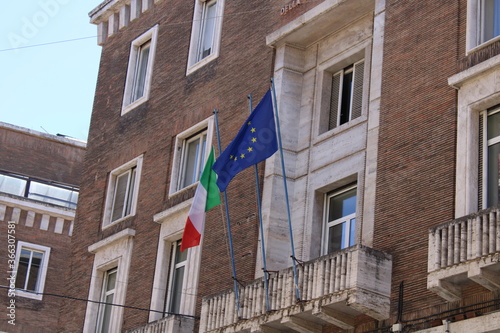 italian flag and european flag on the front of a building in rome italy