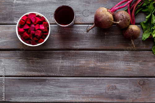 Sliced beet and juice on wooden table top view copy space