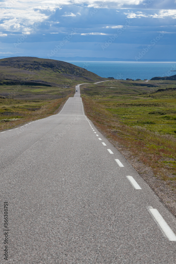 The twisting road through the polar tundra to the Barents Sea, Finnmark, Norway