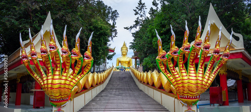 Large golden Buddha on a hill above Pattaya. Thailand. Steps leading to a Buddhist temple.