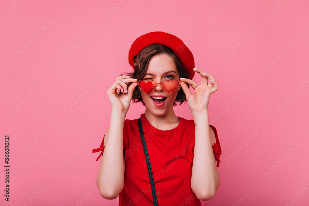 Glad girl having fun during photoshoot dedicated to valentine's day. Indoor photo of funny curly french woman. Glad girl having fun during photoshoot dedicated to valentine's day. Indoor photo of funny curly french woman.