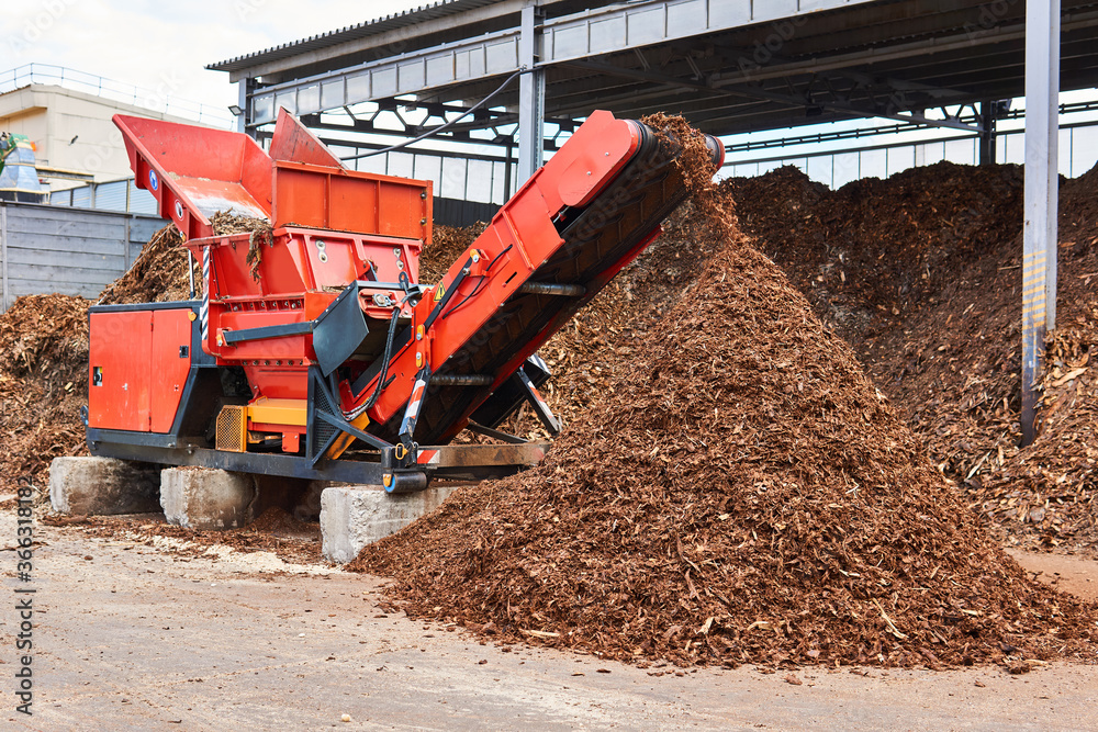 industrial woodchipper producing wood chips