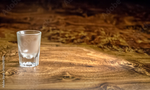 empty shot glass on wood bar table