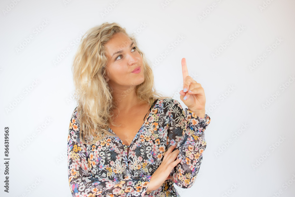 Pretty blonde woman in a flowery dress gesturing on white background Pretty blonde woman in a flowery dress gesturing on white background