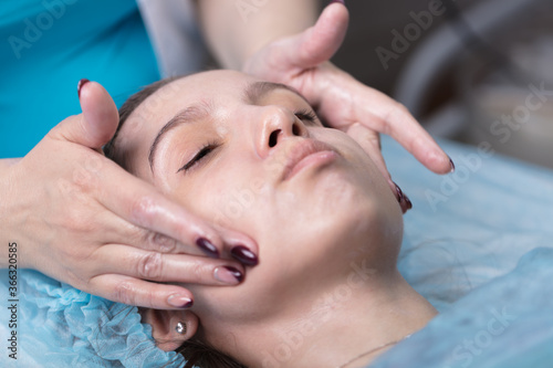 A young woman at a doctor's appointment with a cosmetologist.A beautiful girl is put a rejuvenating mask on her face