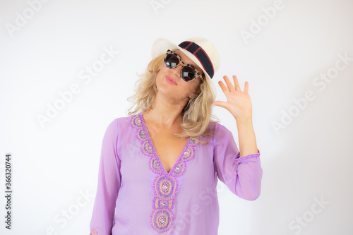 Pretty blonde woman wearing sunglasses and with a lilac caftan