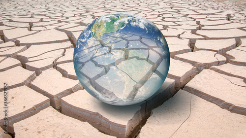 Global warming concept - Glass Globe (Planet Earth) on dry soil "Elements of this image furnished by NASA "