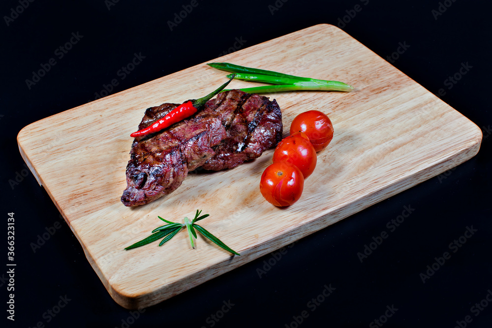 Fresh fried meat. Medium roast beef steak on a wooden chopping Board, with tomatoes, peppers and herbs. The view from the top.
Fresh fried meat. Medium roast beef steak on a wooden chopping Board, with tomatoes, peppers and herbs. The view from the top.