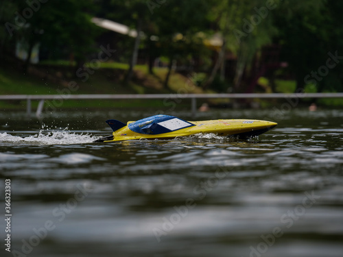 RC controlled jet boat model on lake. Active summer vacation for school child.