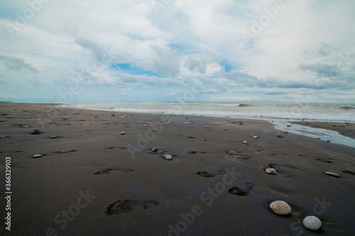 footprints on the beach, volcanic sand photo