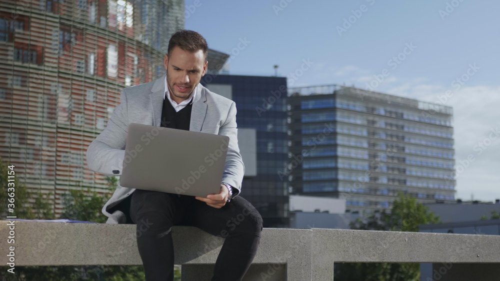 Businessman using laptop for video call outdoors. Freelancer working on laptop Businessman using laptop for video call outdoors. Freelancer working on laptop