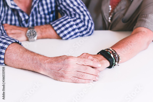 Older couple's hands caressing each other.