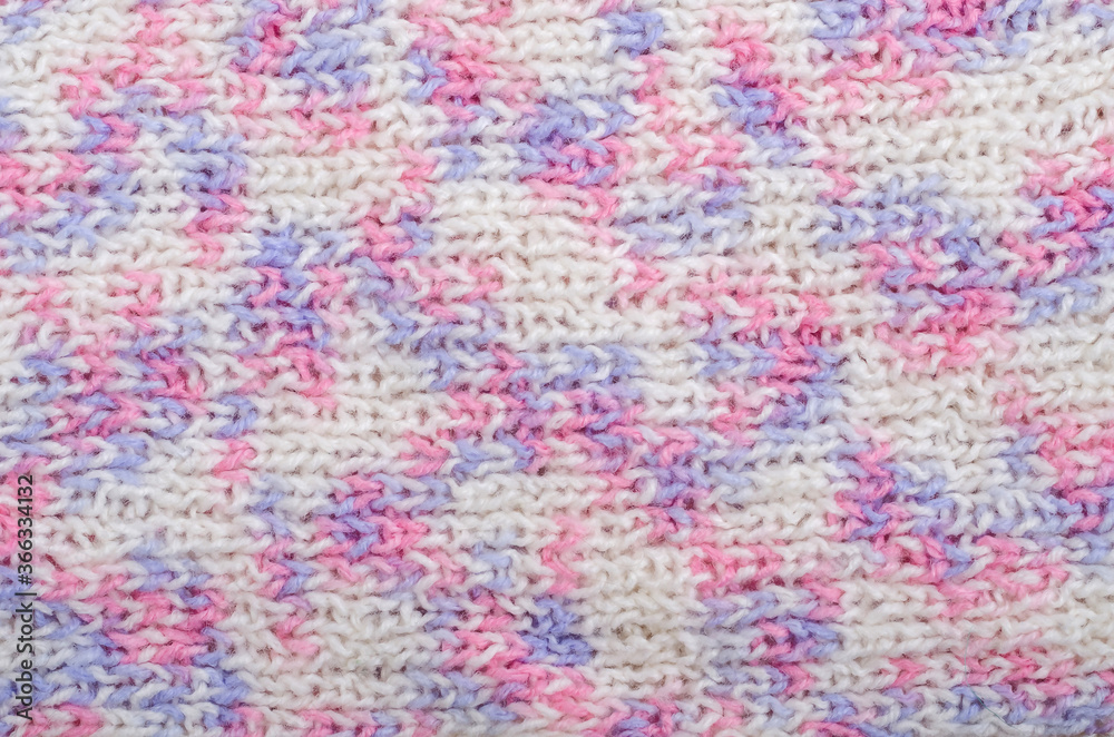 Knitted textured background in delicate white, pink and lilac colors. Winter christmas background Knitted textured background in delicate white, pink and lilac colors. Winter christmas background