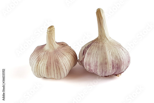 Two whole heads of garlic isolated on a white background.