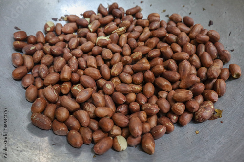 Baking Red grain Peanuts in a steel container. Peanuts background/wallpaper.
