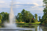 high fountain in the city park and landscape around