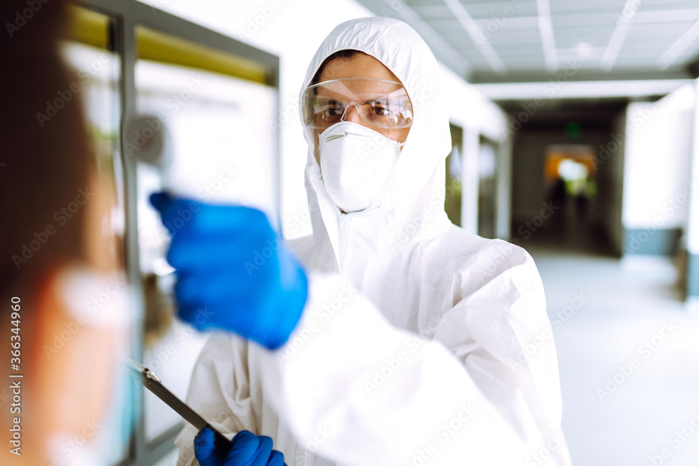 Disease control expert with an Infrared thermometer equipment to check the temperature at office during the coronavirus pandemic. Covid-19. Disease control expert with an Infrared thermometer equipment to check the temperature at office during the coronavirus pandemic. Covid-19.