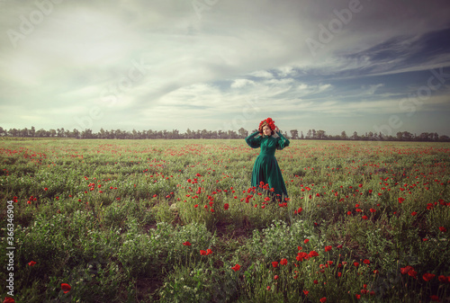 
girl in a poppy field with a wreath of poppies on her head