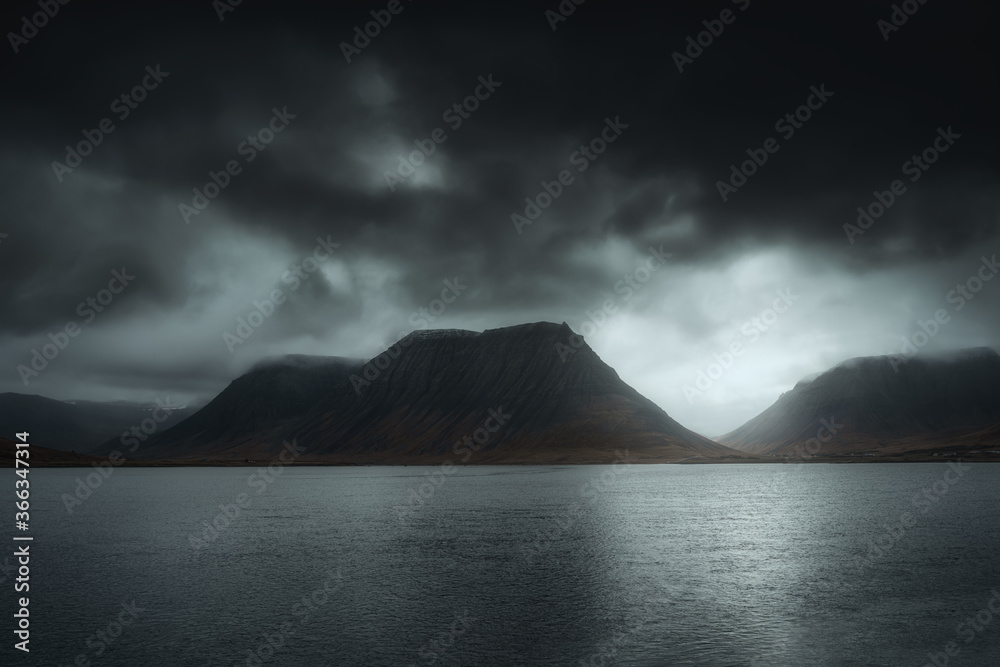 West Fjords or The Westfjords is region in north Iceland. Dramatic moody sky nature landscape. Color toned image