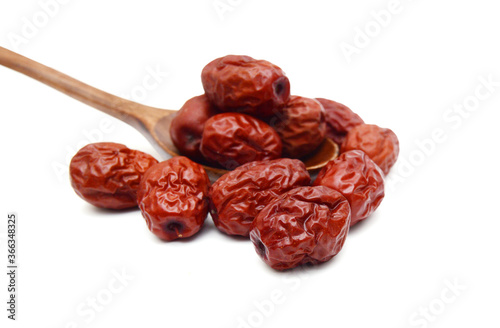 Red date and wooden spoon on white background photo