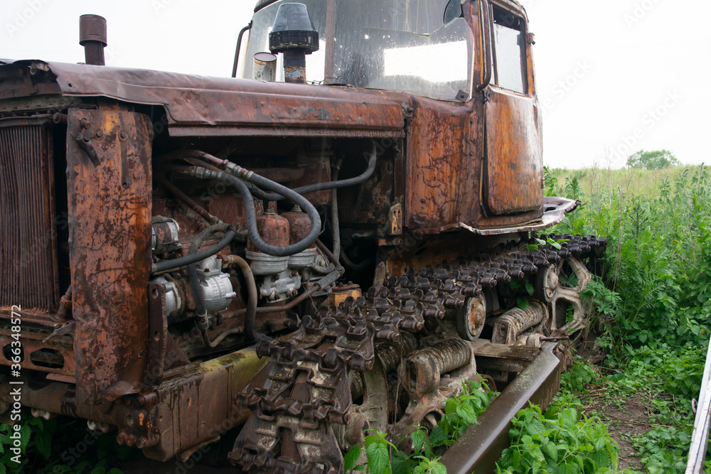 Old ,rusty, rural ,farm ,agricultural, dilapidated ,abandoned ,waste tractor.