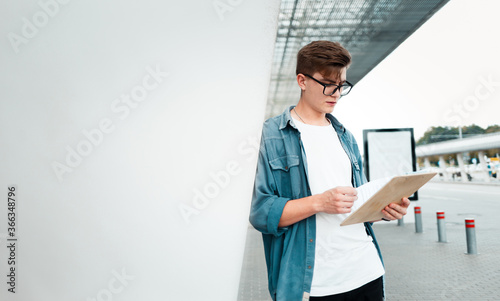 Handsome guy with clipboard reads documents