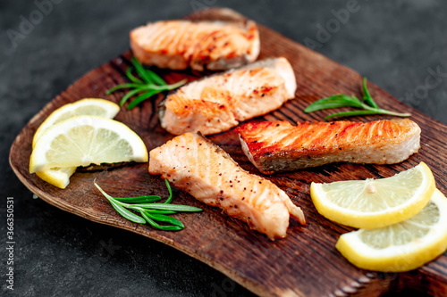 
grilled salmon slices on stone background