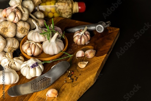 Garlic Cloves and Bulb in vintage wooden bowl. Healthy food. Garlic on a wooden background. Traditional spices.