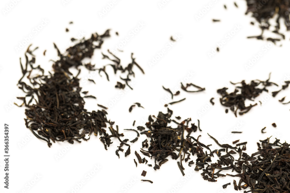 Leaves of black premium dry tea on a white background Leaves of black premium dry tea on a white background