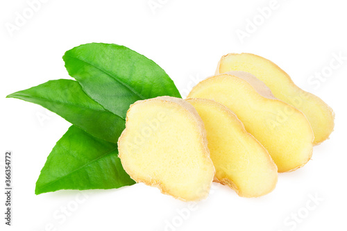 sliced ginger roots with green leaves isolated on white background