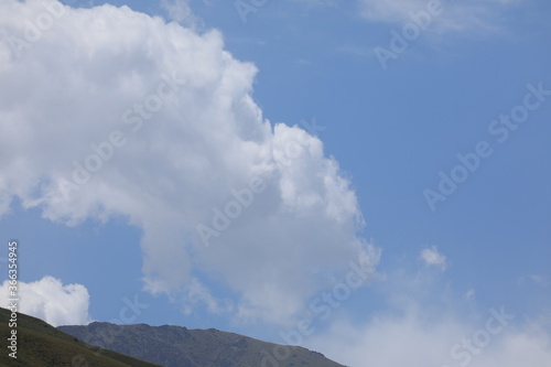 white cloud on blue sky in the hills